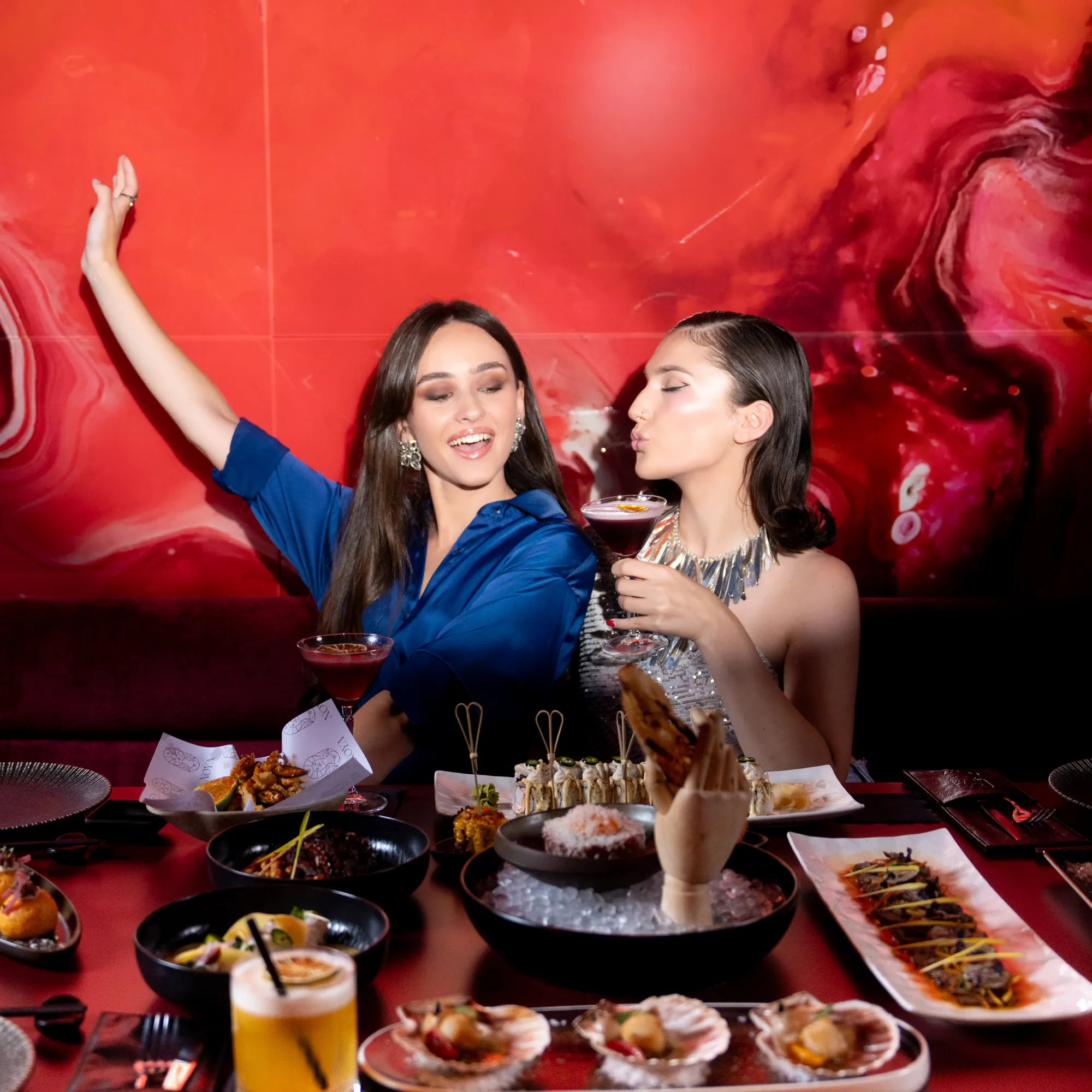 A booth in the lacquer-red room at NOYA